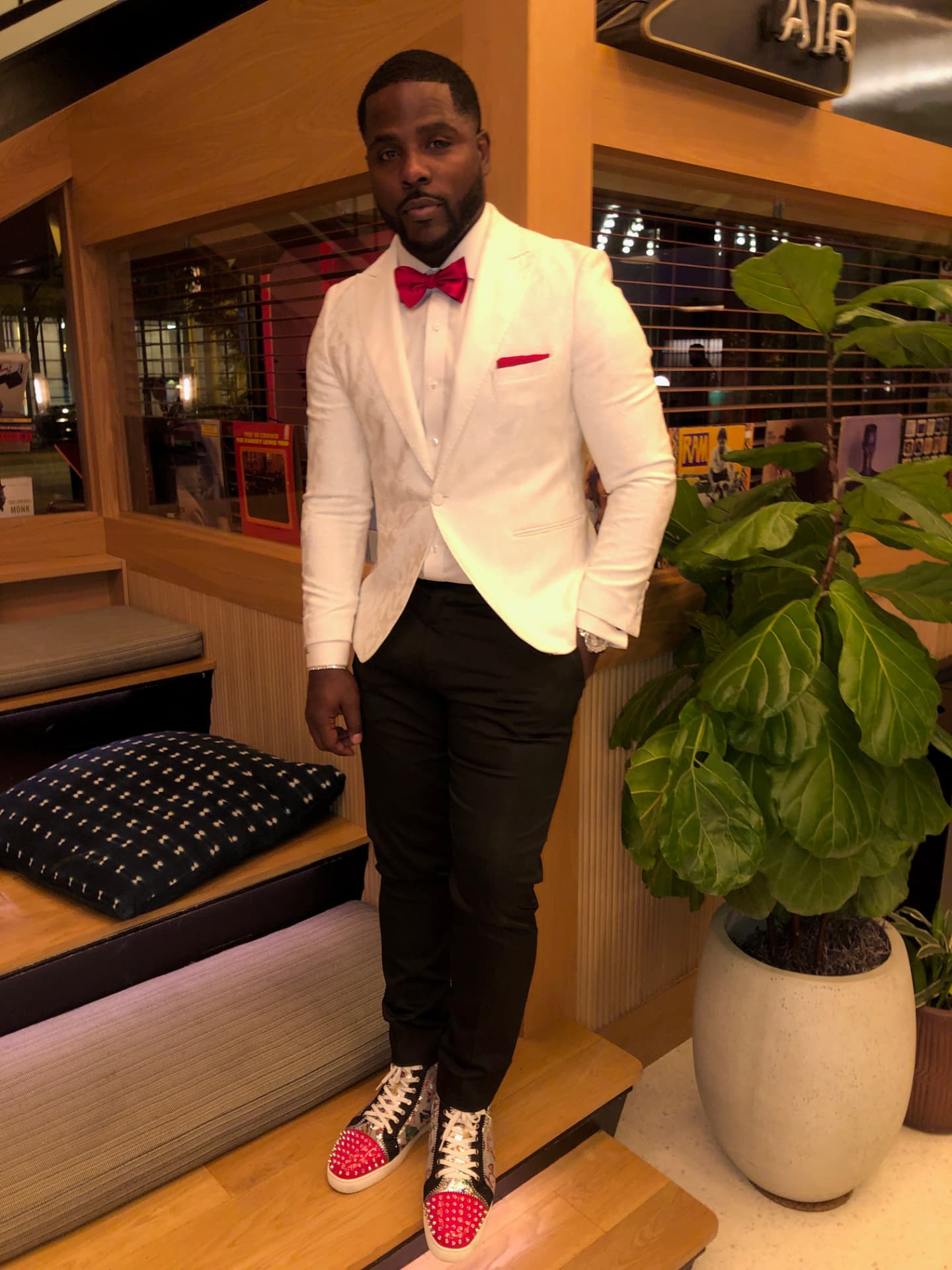 Isiah Williams in a white dinner jacket with a red bow tie