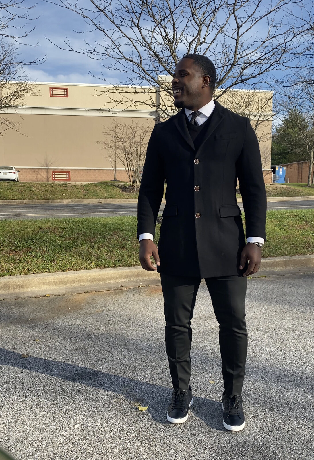 Isiah Williams in a long overcoat and tie