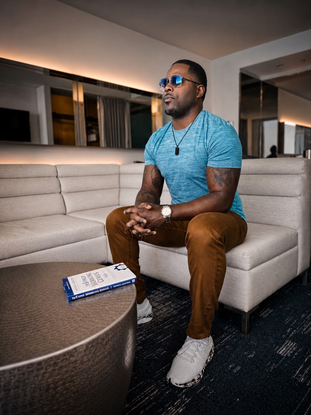 Isiah Williams seated in a lounge with a leadership book on the table