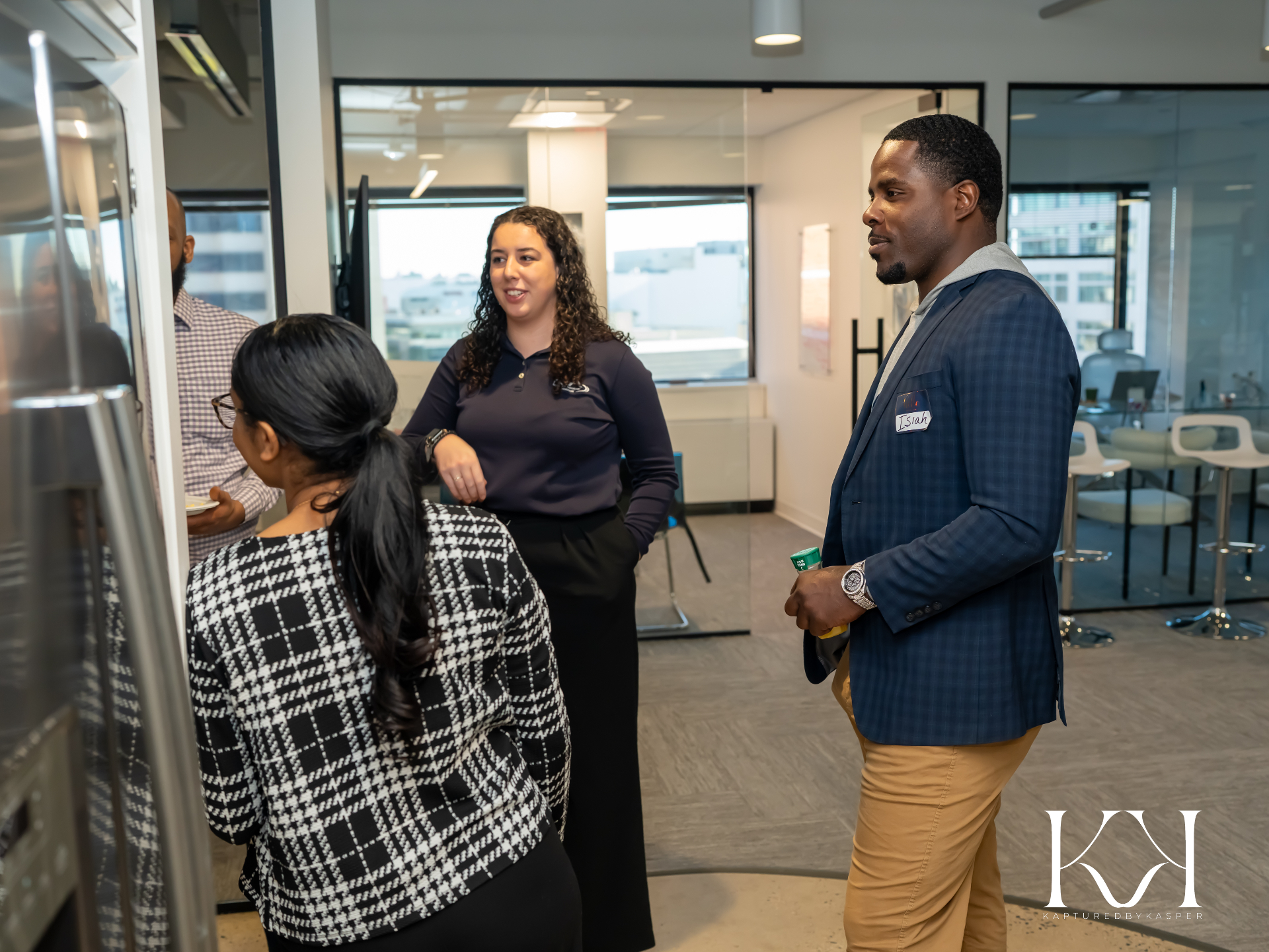 Isiah Williams talking with team members in the Audible Wealth office