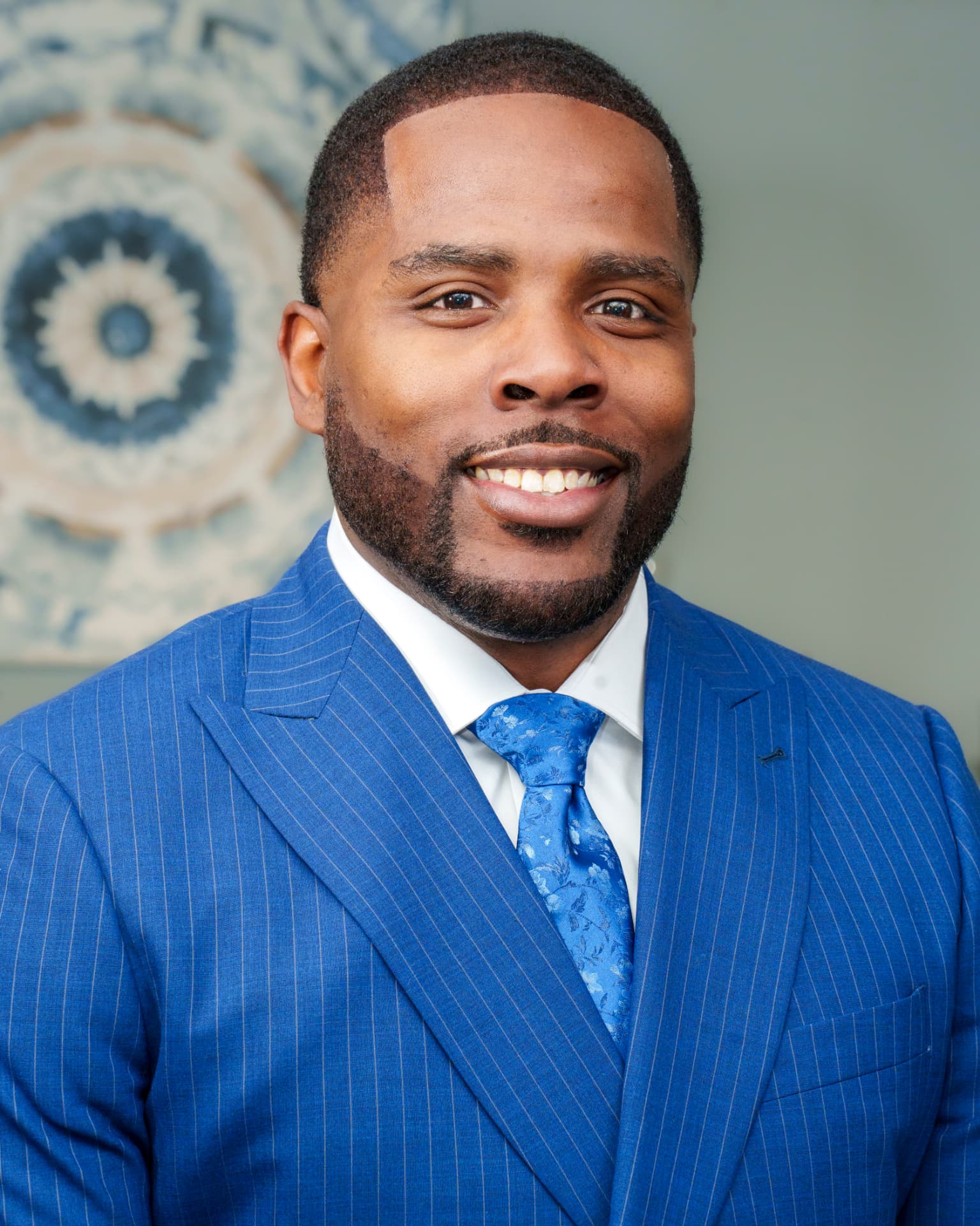 Official headshot of Isiah Williams in a blue pinstripe suit