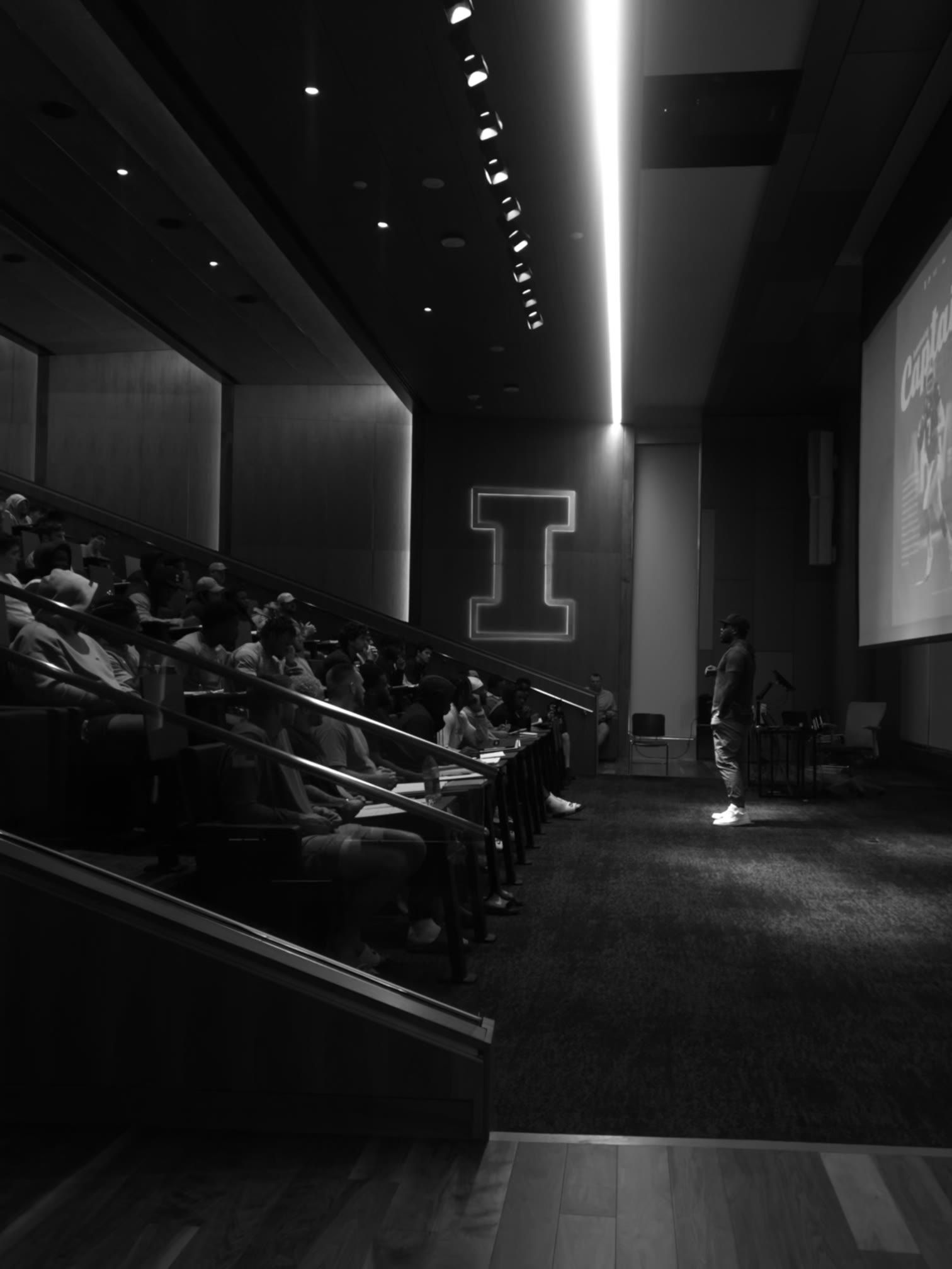 Isiah Williams speaking to a full auditorium audience