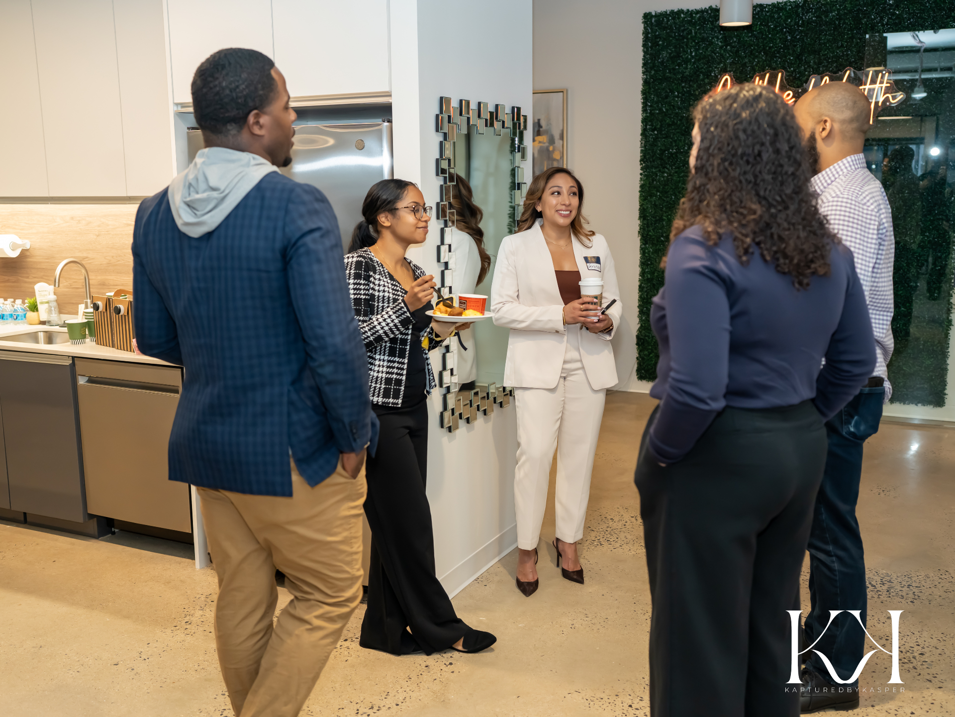 Guests and staff gathered in the Audible Wealth office during an open house
