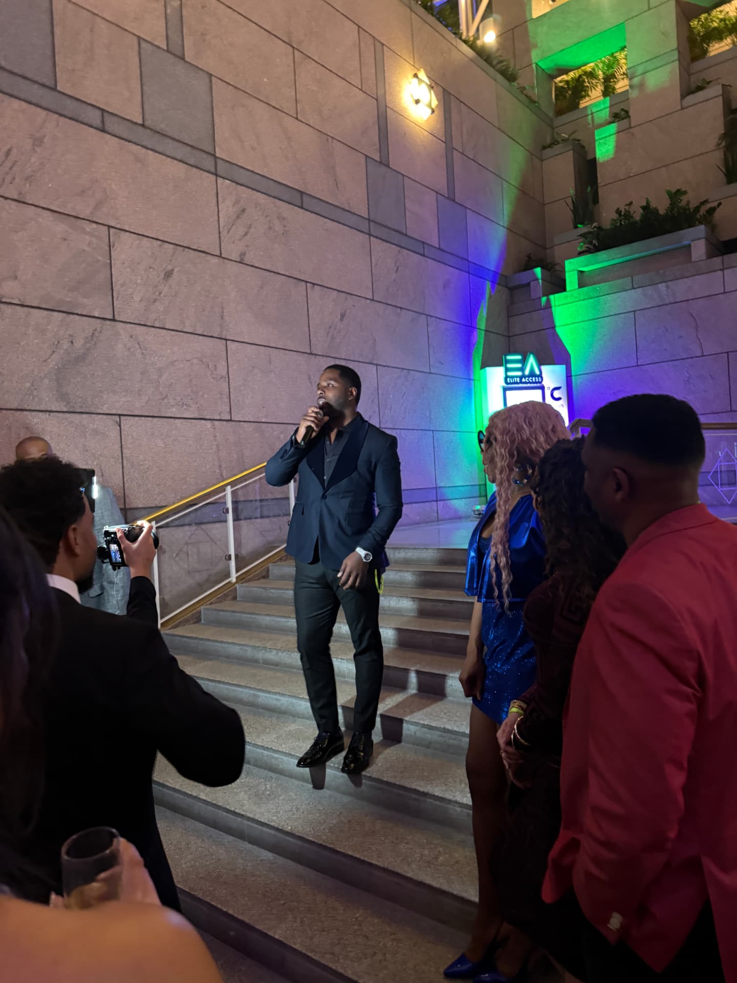 Isiah Williams speaking to an audience at an evening event